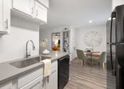 Thumbnail 4 of 37 - a kitchen with a sink and a large clock on the wall