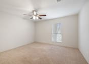 Thumbnail 7 of 37 - the living room of an empty home with a ceiling fan