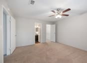 Thumbnail 8 of 37 - a spacious living room with white walls and a ceiling fan