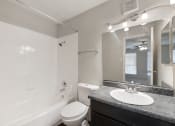 Thumbnail 10 of 37 - a bathroom with a shower sink and toilet and a mirror