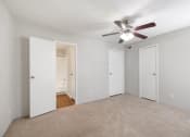 Thumbnail 9 of 37 - an empty living room with a ceiling fan and white doors