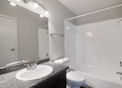 Thumbnail 23 of 37 - a bathroom with a sink toilet and shower and a mirror