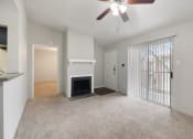 Thumbnail 6 of 37 - an empty living room with a fireplace and a ceiling fan