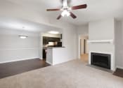 Thumbnail 1 of 37 - an empty living room with a fireplace and a ceiling fan