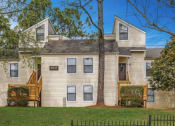 Thumbnail 8 of 16 - a house with a yard and a tree in front of it