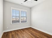 Thumbnail 36 of 38 - A room with a window and wooden flooring.