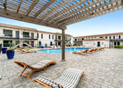 Thumbnail 6 of 22 - a resort style pool with lounge chairs and a pergola