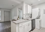 Thumbnail 16 of 38 - A kitchen with white cabinets and a white counter top.