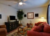 Thumbnail 5 of 8 - a living room with a red couch and a television