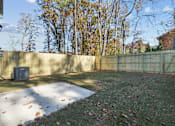 Thumbnail 18 of 22 - A backyard with a fence and a tree.