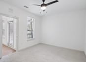 Thumbnail 29 of 33 - A room with a ceiling fan and a window with blinds.