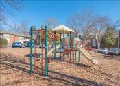 Thumbnail 11 of 14 - a playground with a slide in a park