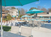 Thumbnail 6 of 14 - a pool with a bunch of chairs and umbrellas