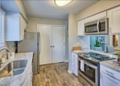 Thumbnail 14 of 14 - a kitchen with a stove top oven next to a sink