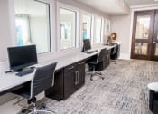 Thumbnail 7 of 33 - a large office with desks and chairs with computers