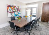 Thumbnail 6 of 33 - a conference room with a table and chairs and a painting on the wall