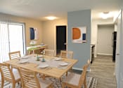Thumbnail 8 of 19 - A dining room with a table set for two.
