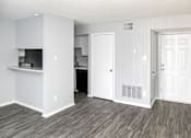Thumbnail 10 of 19 - A kitchen area with a refrigerator, microwave, and oven.