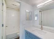 Thumbnail 9 of 19 - a bathroom with a sink and a mirror