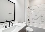 Thumbnail 37 of 38 - A white sink with a black mirror above it.