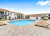 Thumbnail 5 of 22 - a large swimming pool in front of a group of apartments