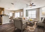 Thumbnail 2 of 39 - a living room with a couch and chairs and a ceiling fan