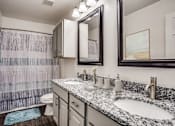 Thumbnail 6 of 39 - a bathroom with two sinks and a shower and a toilet