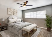 Thumbnail 3 of 39 - a bedroom with a bed and a ceiling fan