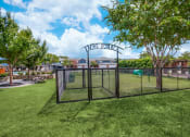 Thumbnail 15 of 39 - a dog park with a chain link fence and a gate