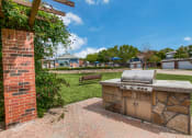 Thumbnail 14 of 39 - the preserve at ballantyne commons outdoor kitchen with grill and grass