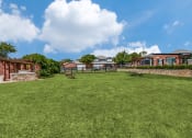 Thumbnail 37 of 39 - the backyard of a house with a large lawn and a stone wall