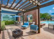 Thumbnail 10 of 39 - the preserve at ballantyne commons pool area with patio furniture and umbrellas