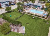 Thumbnail 20 of 39 - an aerial view of a pool and a yard with lounge chairs