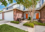 Thumbnail 32 of 39 - the front of a brick house with an orange door