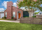 Thumbnail 26 of 39 - the front of a brick house with a wooden fence