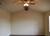 Thumbnail 3 of 8 - an empty living room with a ceiling fan