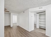 Thumbnail 13 of 26 - A room with white walls and wooden flooring.
