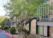 Thumbnail 36 of 36 - a building with a staircase and trees in front of it