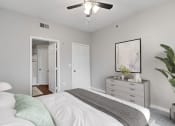 Thumbnail 7 of 32 - an empty bedroom with a bed and a ceiling fan