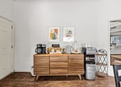 Thumbnail 8 of 39 - a kitchen with a wooden dresser and a coffee maker on top of it