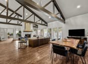 Thumbnail 5 of 39 - a living room with a dining room table and a tv