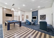Thumbnail 11 of 24 - A room with a pool table and a television.