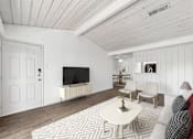 Thumbnail 3 of 35 - A living room with a white couch, a coffee table, and a television.