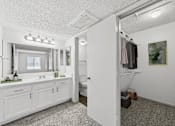 Thumbnail 9 of 35 - A bathroom with a white vanity and a white door.