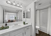 Thumbnail 10 of 35 - A white bathroom with a sink, mirror, and shower.