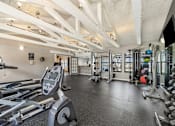 Thumbnail 24 of 35 - A gym with treadmills, weights, and exercise equipment.