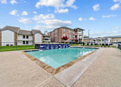 Thumbnail 9 of 18 - A swimming pool surrounded by a concrete floor and a fence.