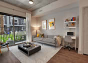 Thumbnail 2 of 17 - a living room with a couch and a coffee table in front of a large window