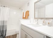 Thumbnail 10 of 20 - a bathroom with a shower and a sink and a mirror