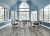 Thumbnail 15 of 20 - a dining room with a large window and tables and chairs